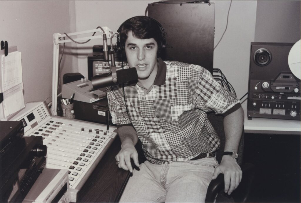 Tom Hardie sits at the mic in Osprey radio.