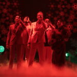 Pentatonix on stage, singing with smoke blowing at their feet.