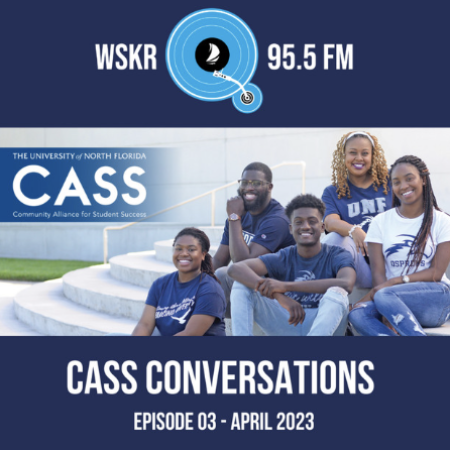 5 people sitting on a stair case in blue t shirts smiling at the camera