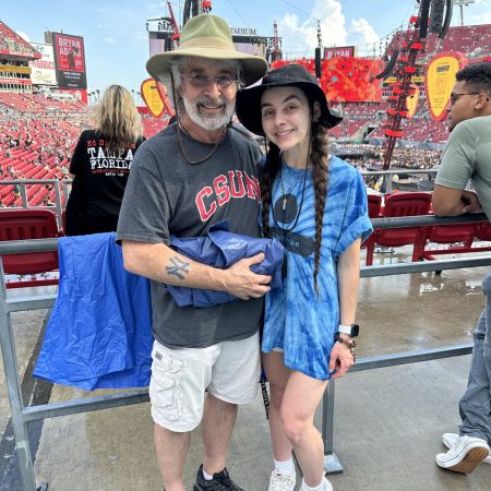 Lisa and her dad wearing bucket hats in front of Ed Sheeran's stage.