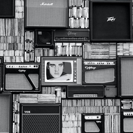 Guitar amps stacked on top of each other and CDs stacked on top of each other.