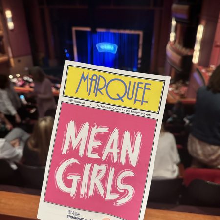 Mean Girls the Musical pink and white program.